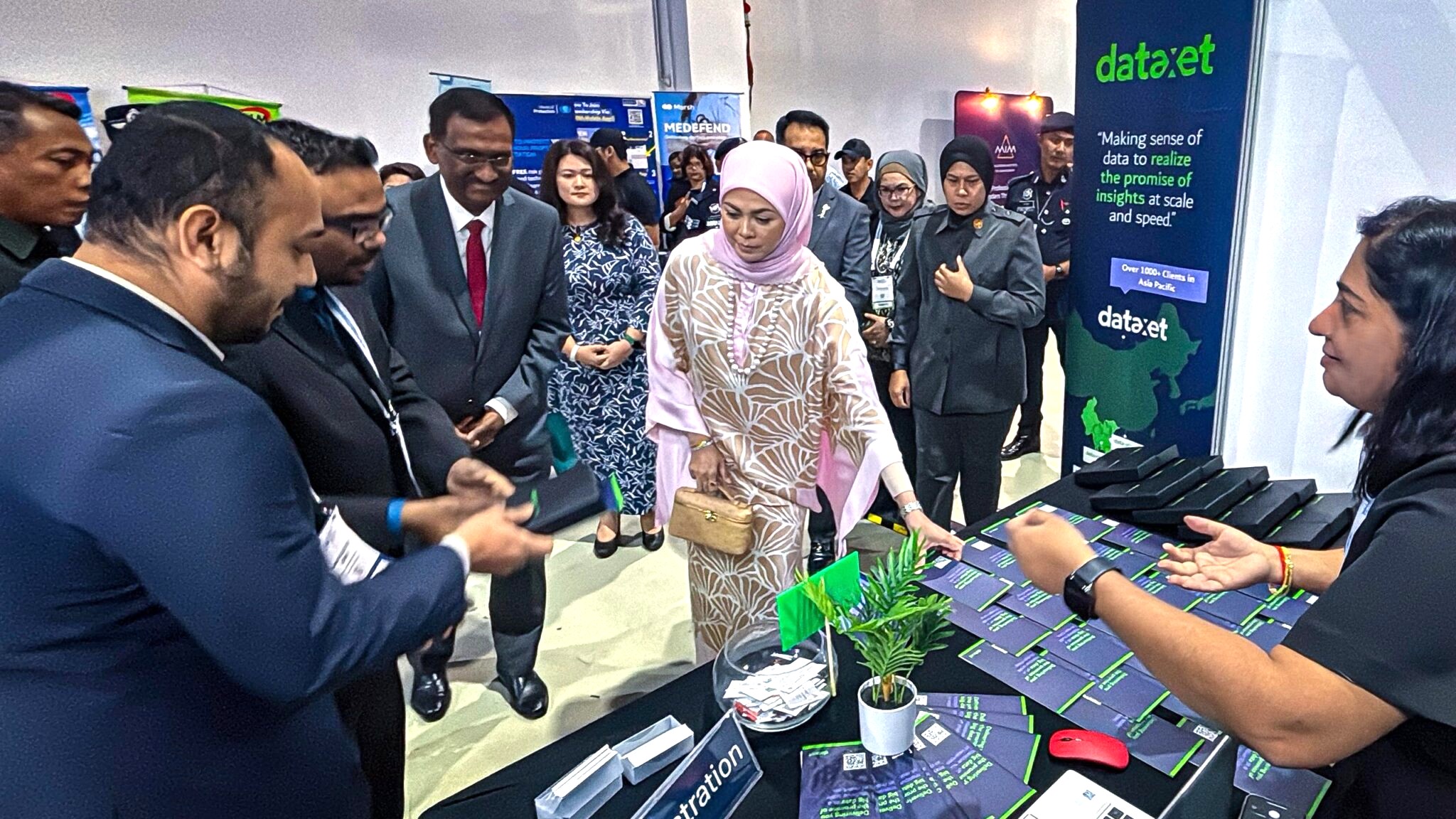 Tengku Permaisuri Norashikin of Selangor and Minister Fahmi Fadzil visit the Dataxet Malaysia booth at GPRCF 2025, observing the AI-powered media intelligence solutions.